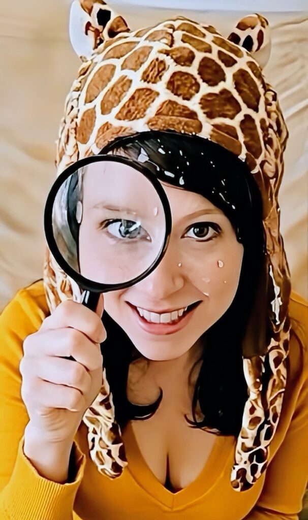 Velma cosplay facials in a giraffe hat and magnifying glass 